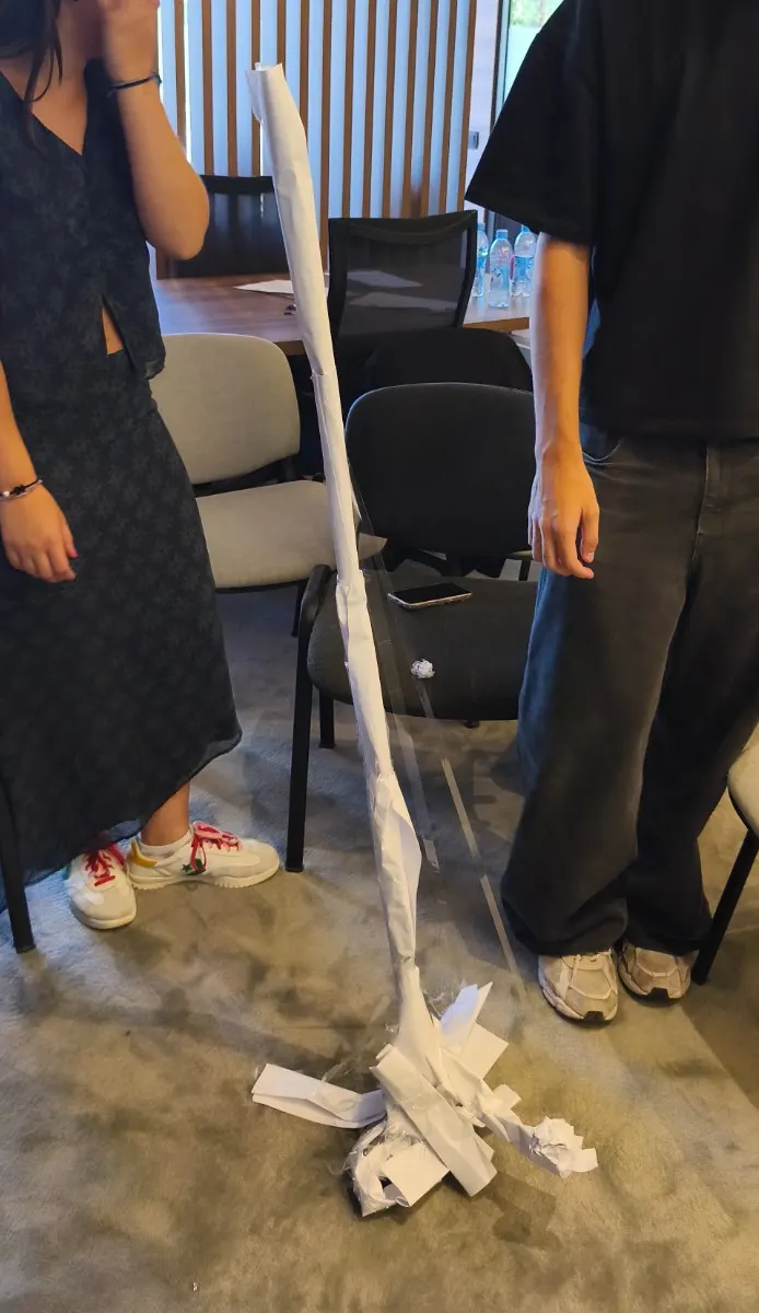 Build the tallest stable free-standing structure possible using: 10 sheets of paper and 1 meter of tape